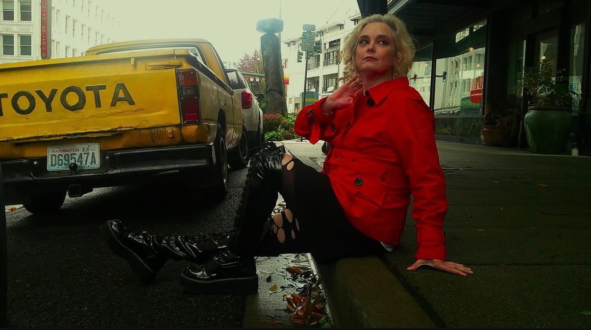 Woman in red jacket on urban Seattle street